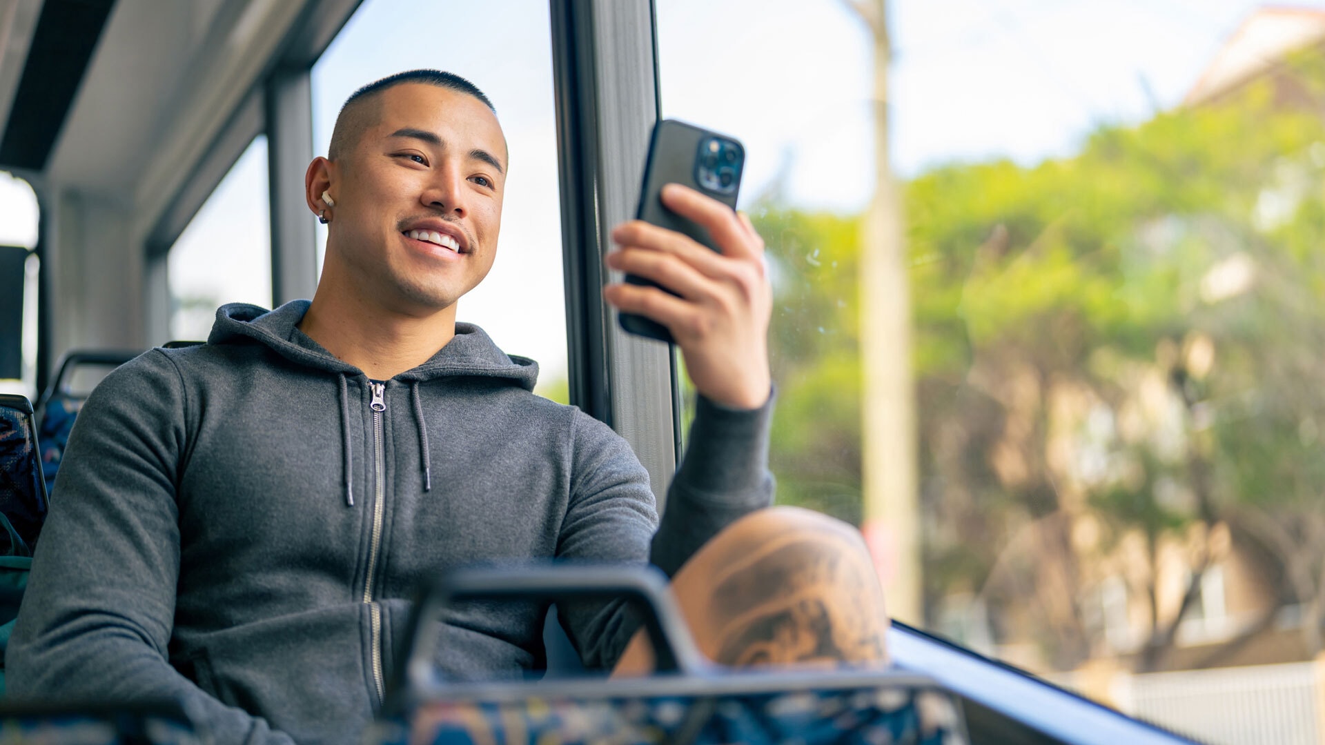 Young man on public transport with phone men masc