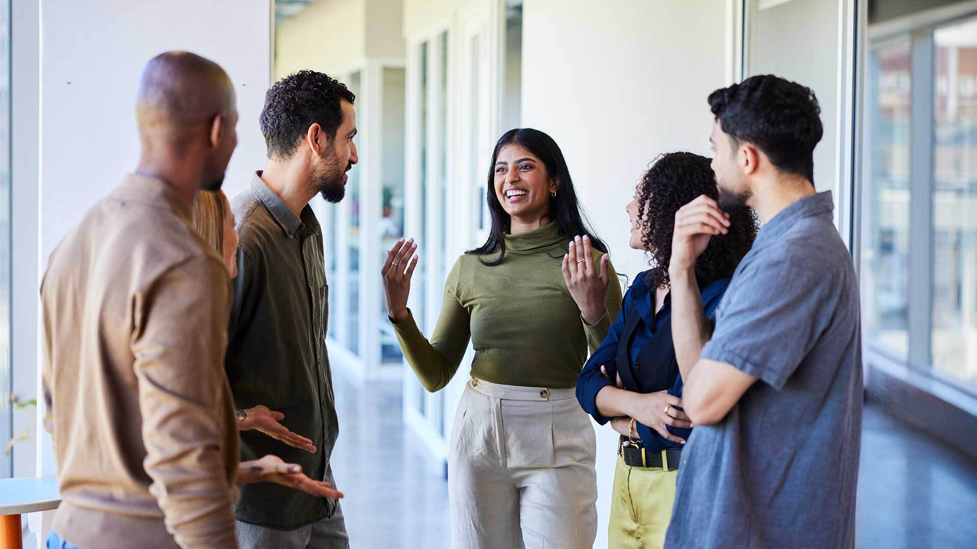 Workplace group of coworkers talking