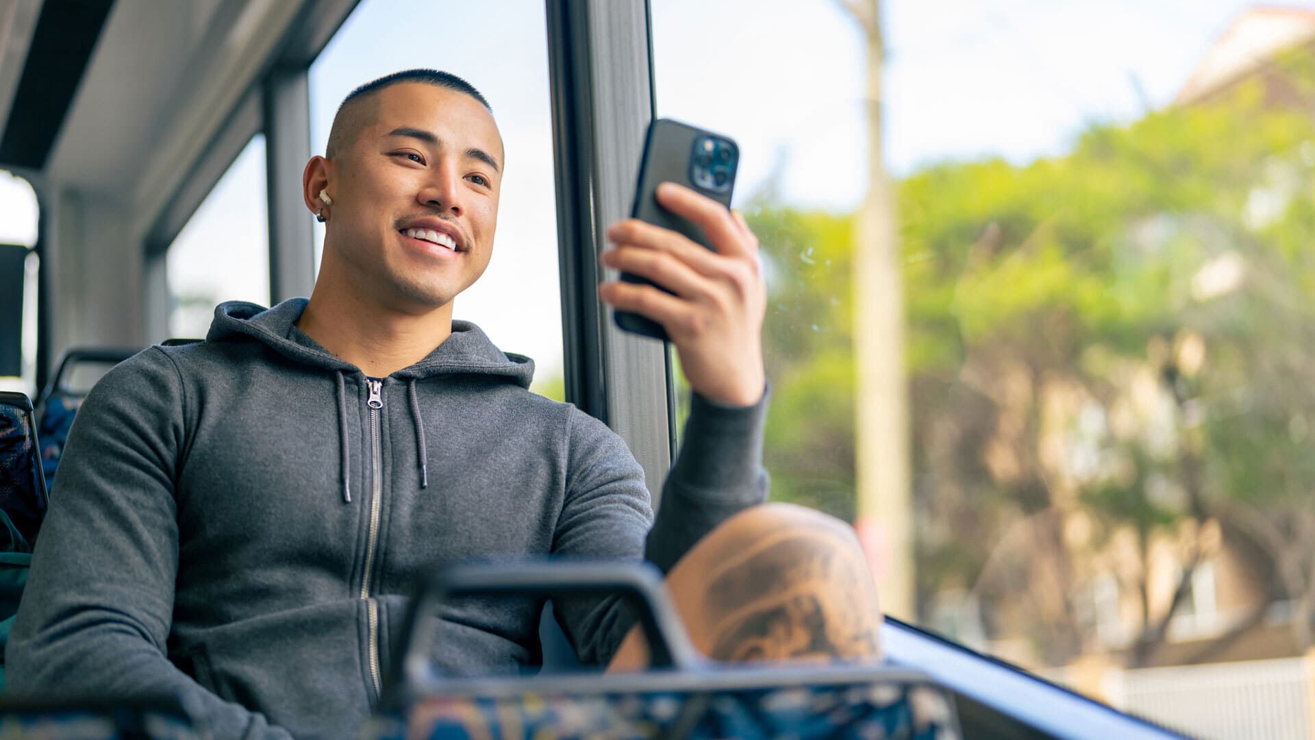 Young man on public transport with phone men masc