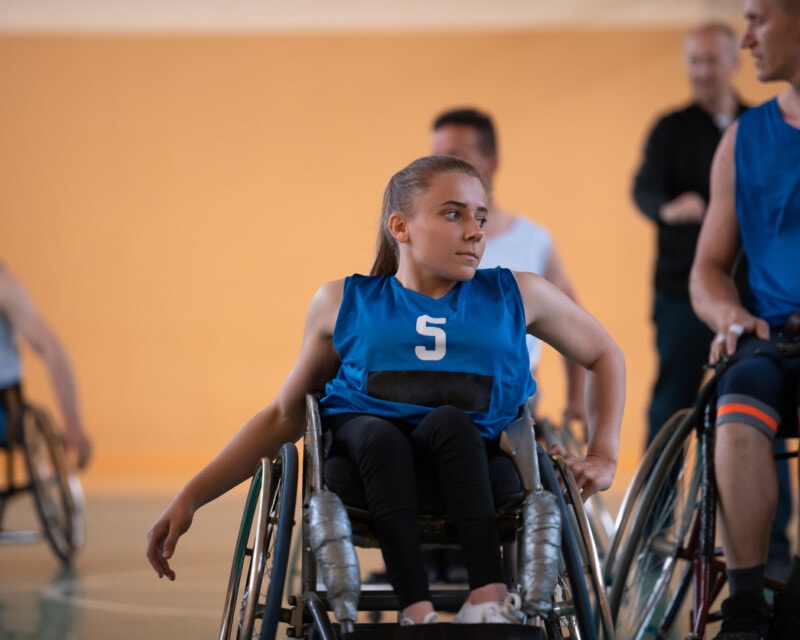 A young woman playing wheelchair basketball in a professional team.