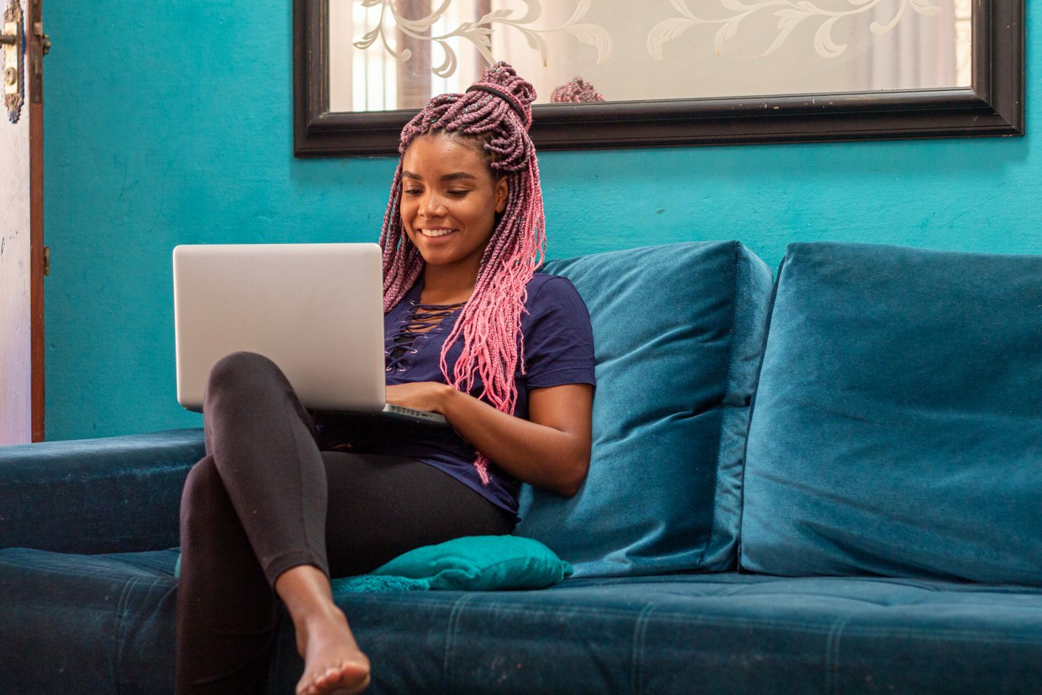 I Stock 1226859691 e1668482655499 PiA Young woman with braids using notebook in home room
